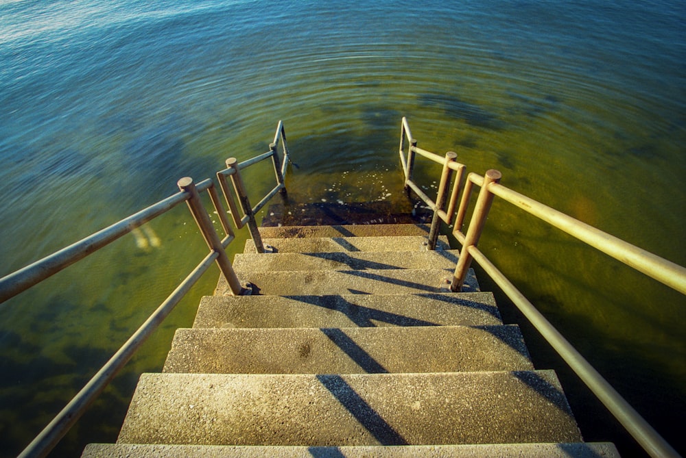 a set of stairs leading to a body of water