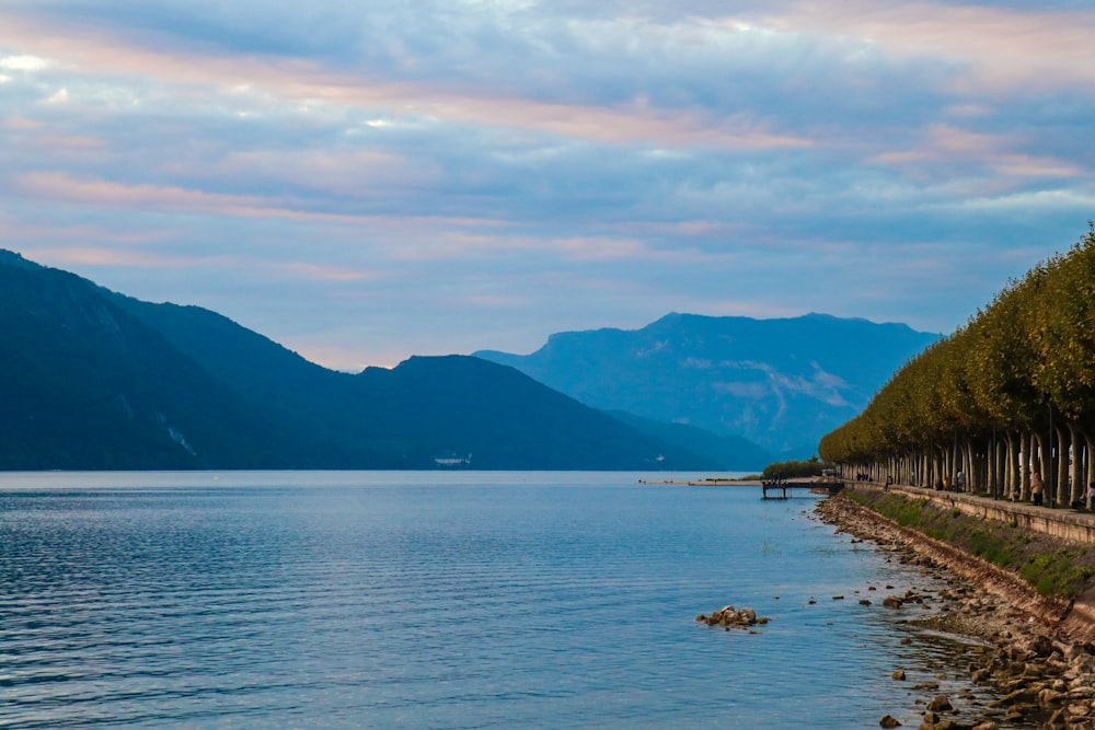 a body of water with mountains in the background