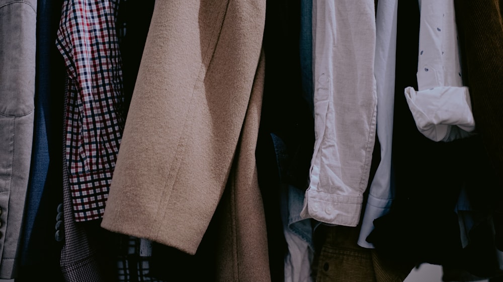 a bunch of clothes hanging on a rack