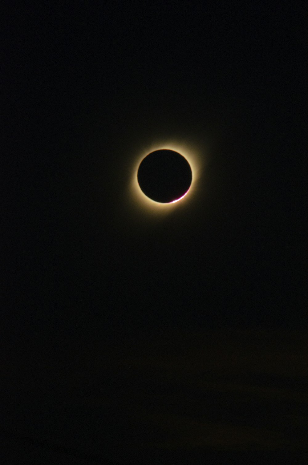 a solar eclipse is seen in the dark sky