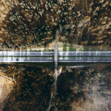 Aerial view of a newly constructed highway surrounded by greenery.