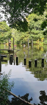 A serene team-building event with people enjoying nature trails and light activities in calming beige and brown hues.