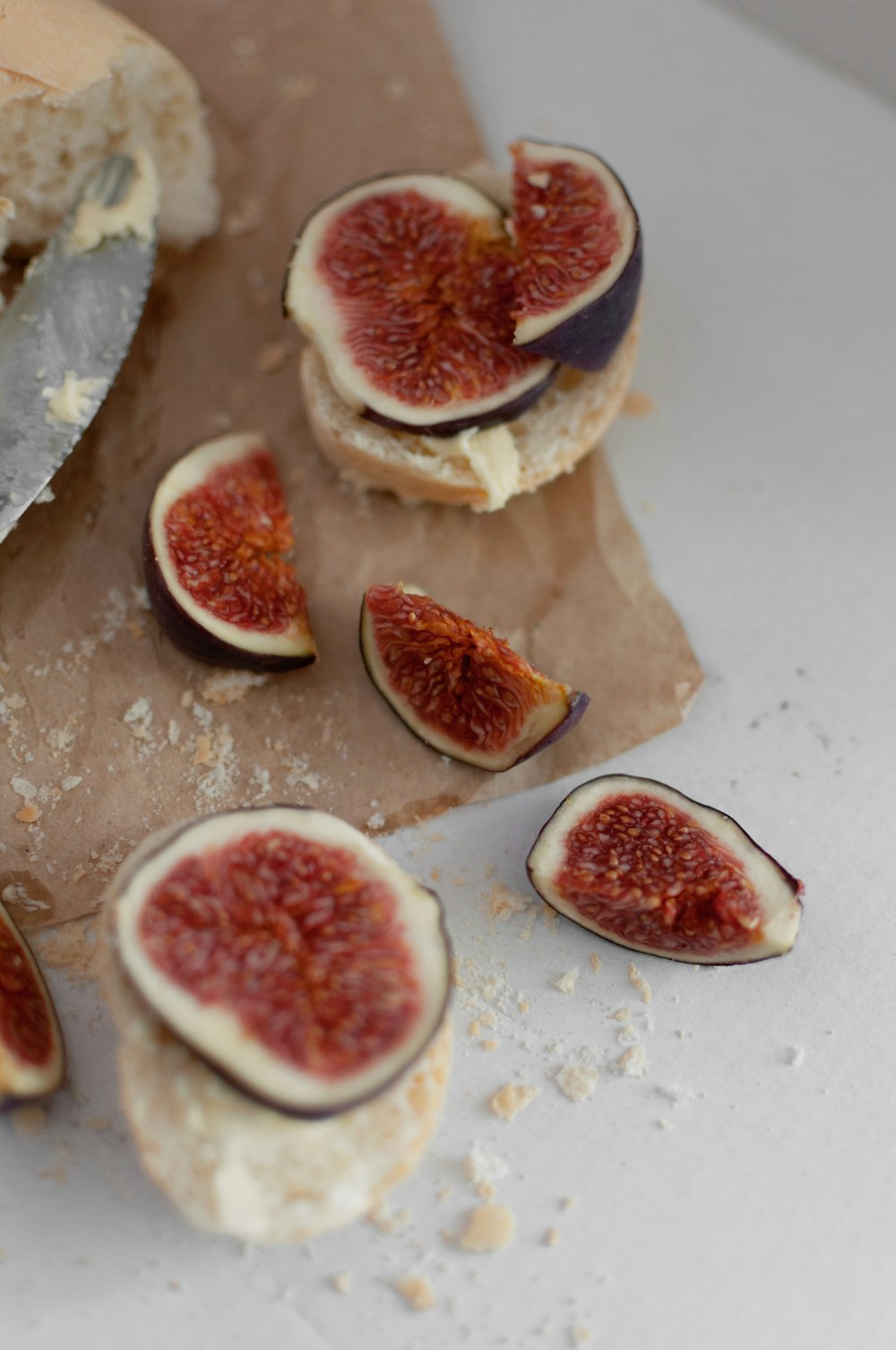 a bagel with figs cut in half on a table