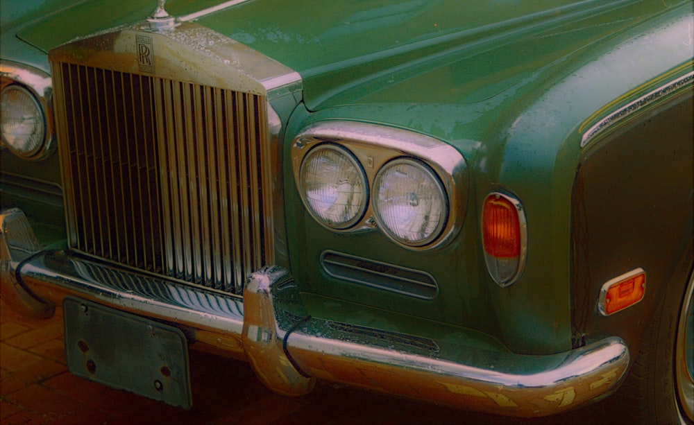 a close up of the front of a green car