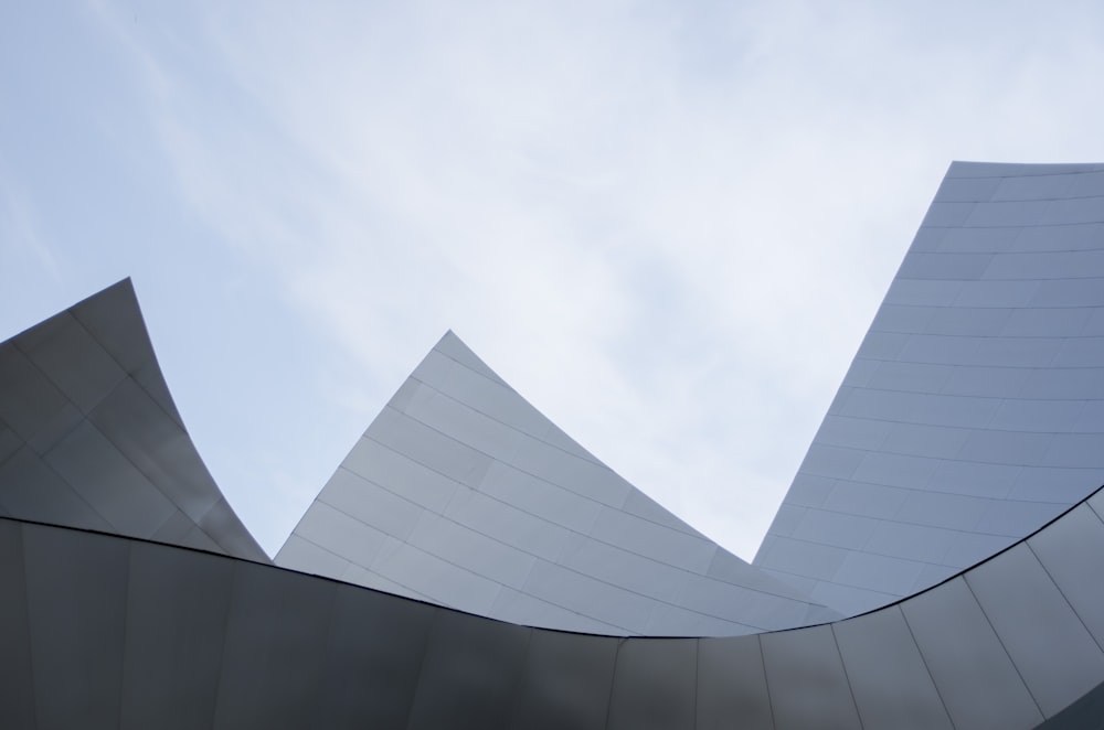 a curved building with a sky in the background