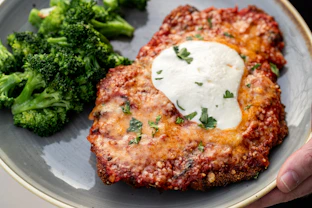 a plate of food with meat and broccoli