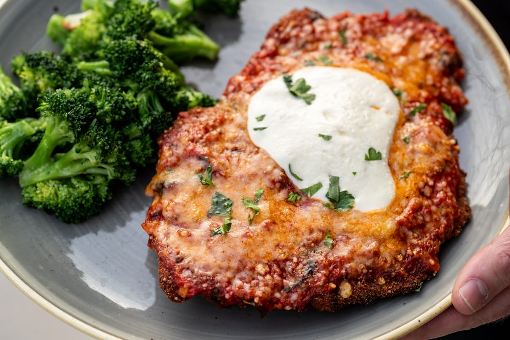 a plate of food with meat and broccoli