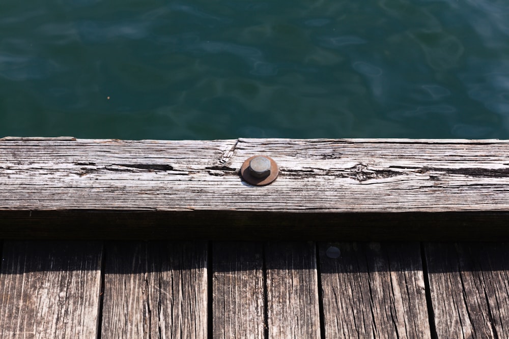 a close up of a wooden dock with water in the background