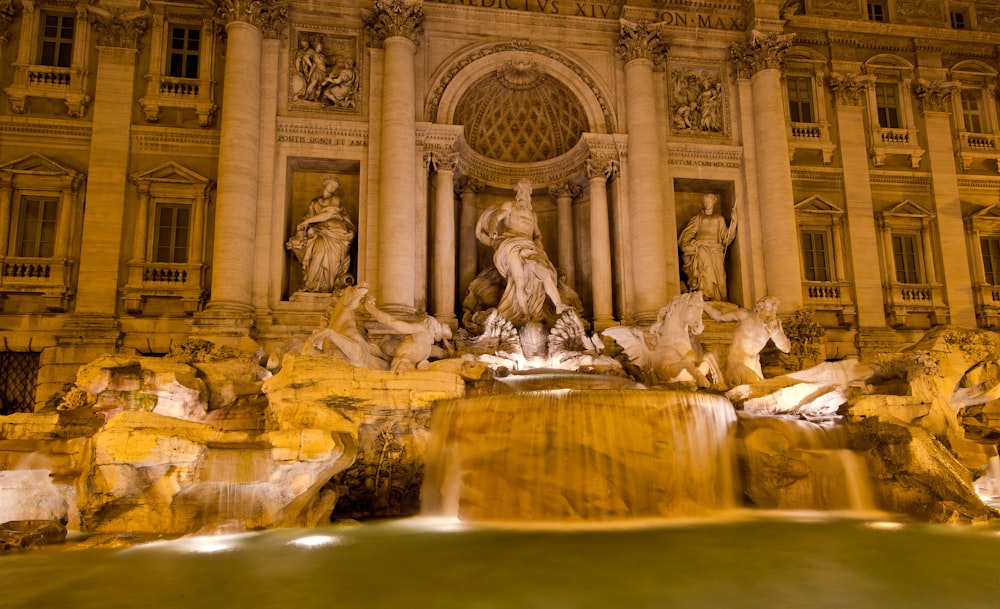 a large building with a fountain in front of it