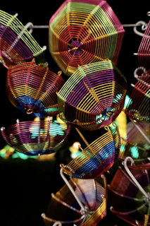 A variety of wireforms displayed on a wooden table, showcasing intricate bends and shapes.