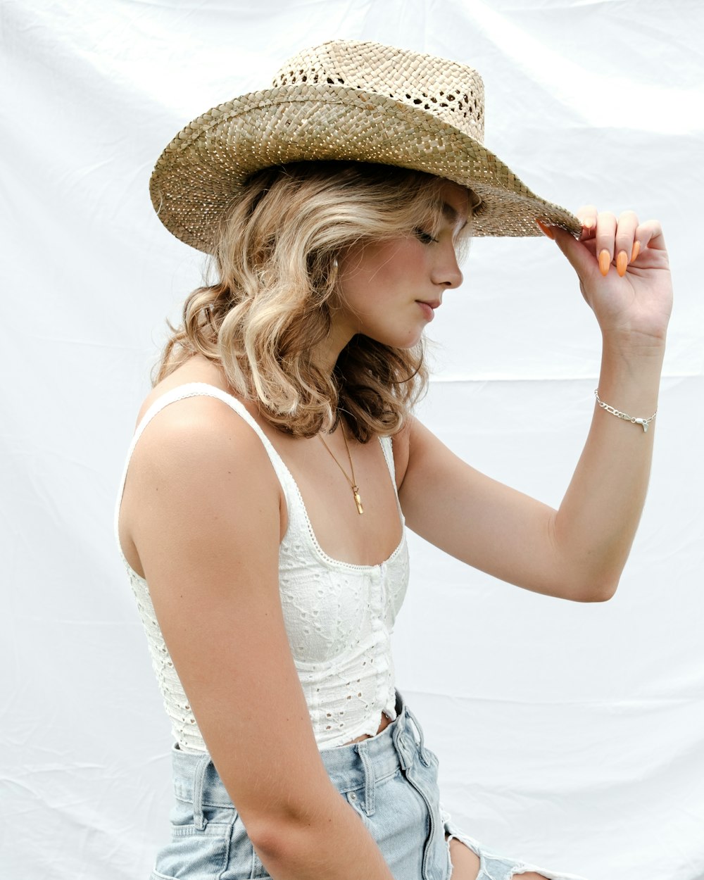 a woman in a straw hat poses for a picture