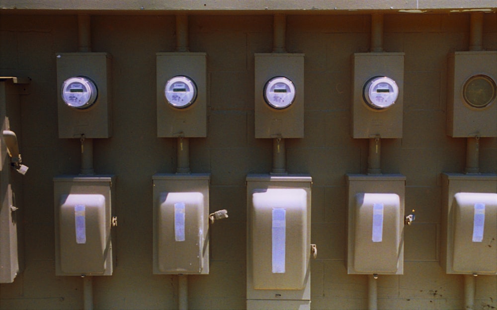 a row of urinals mounted to the side of a wall