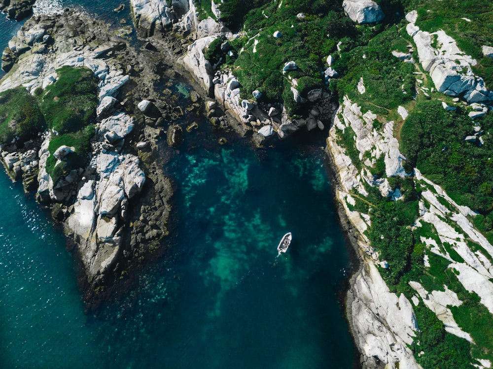 an aerial view of a boat on a body of water