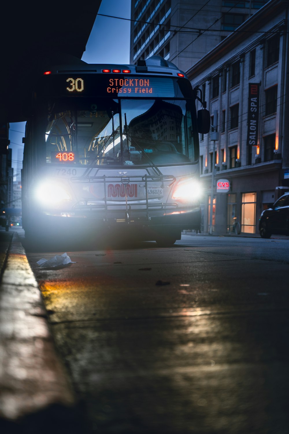 a bus driving down a street at night