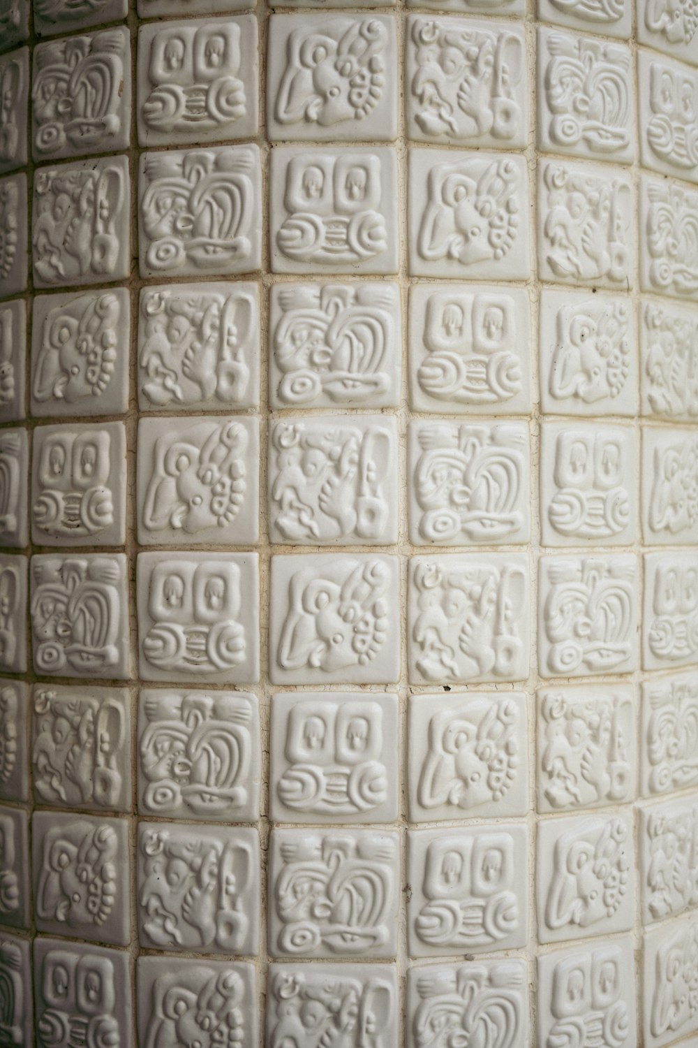 a close up of a white tile wall