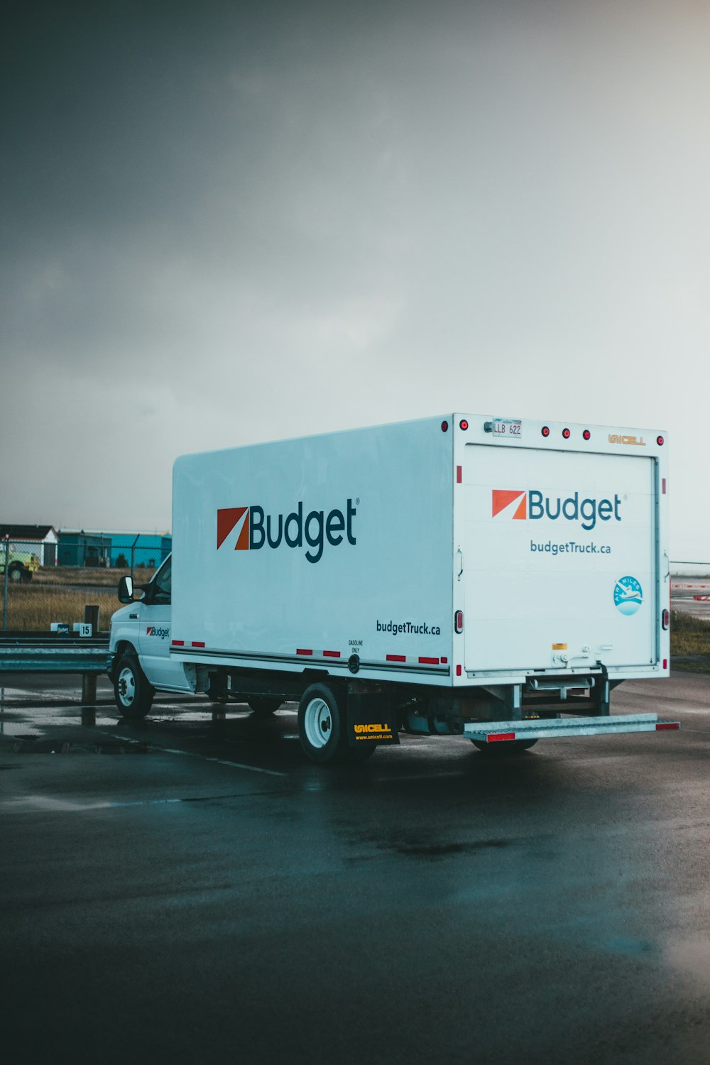 a blue and white truck parked in a parking lot