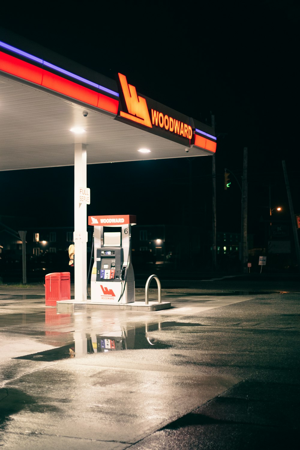 a gas station at night with a gas pump