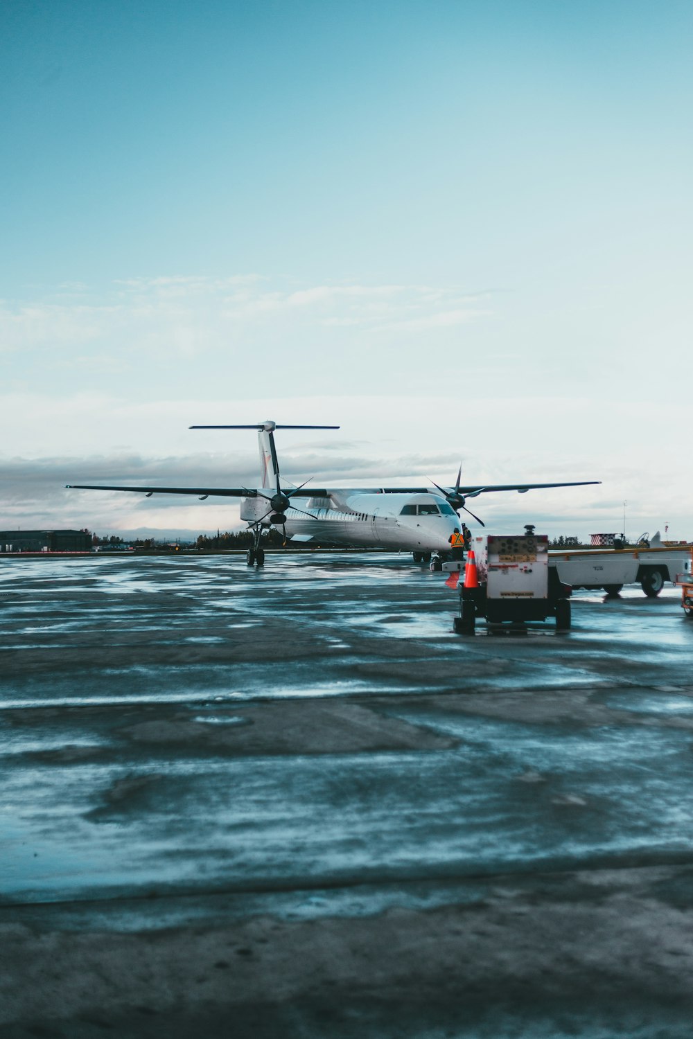 a plane is parked on the tarmac at an airport