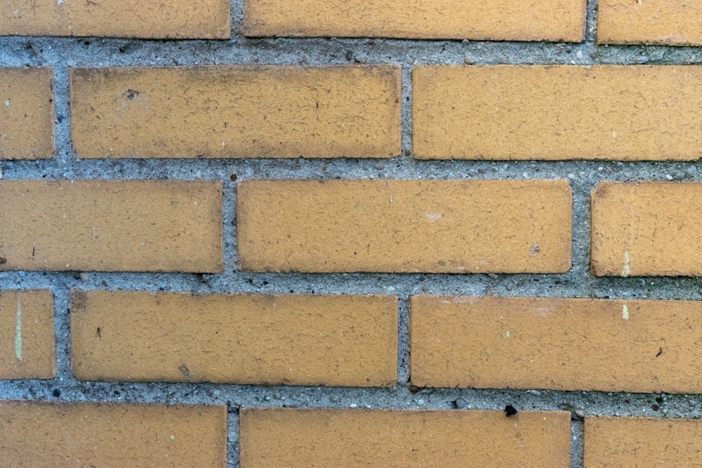 a close up of a yellow brick wall