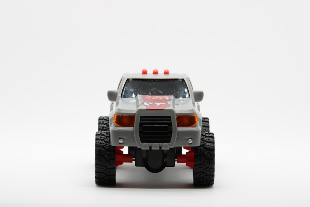 um caminhão de brinquedo é mostrado em um fundo branco
