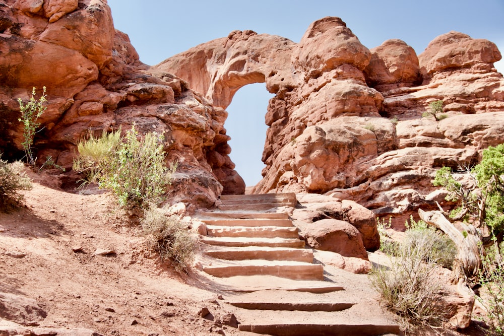 a set of steps leading up to a rock arch