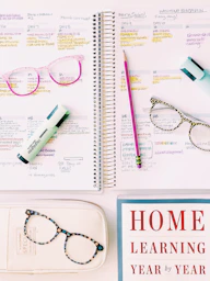 a notebook with glasses and a book on it