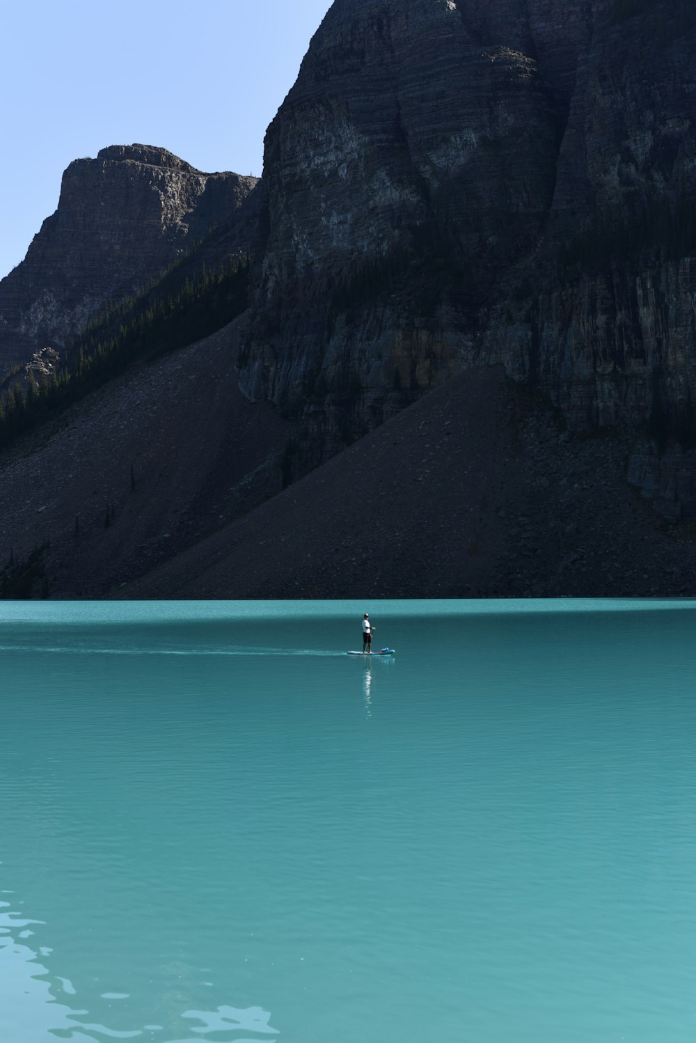 a lone person in the middle of a large body of water