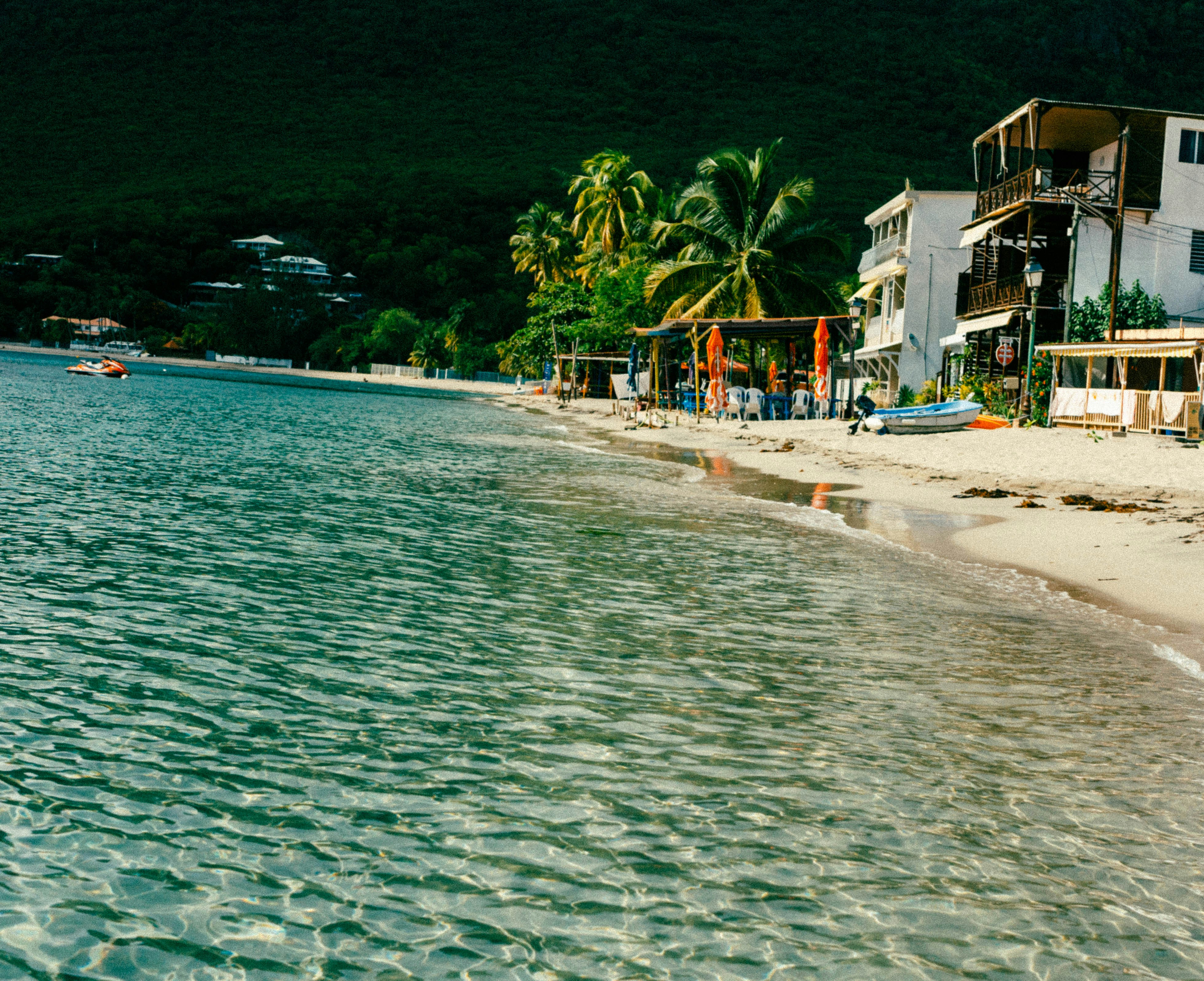 a body of water next to a sandy beach