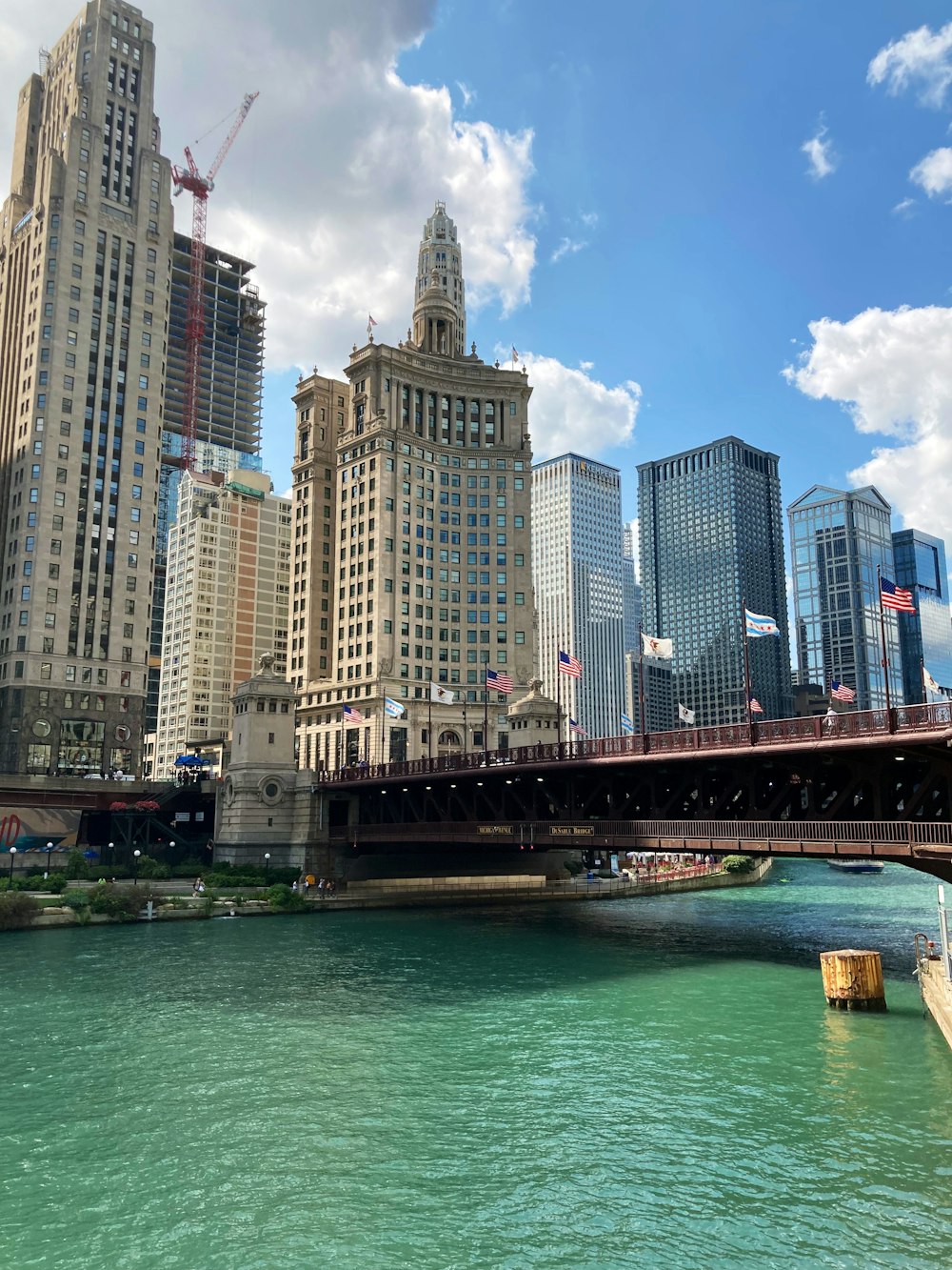 a bridge over a body of water with a city in the background