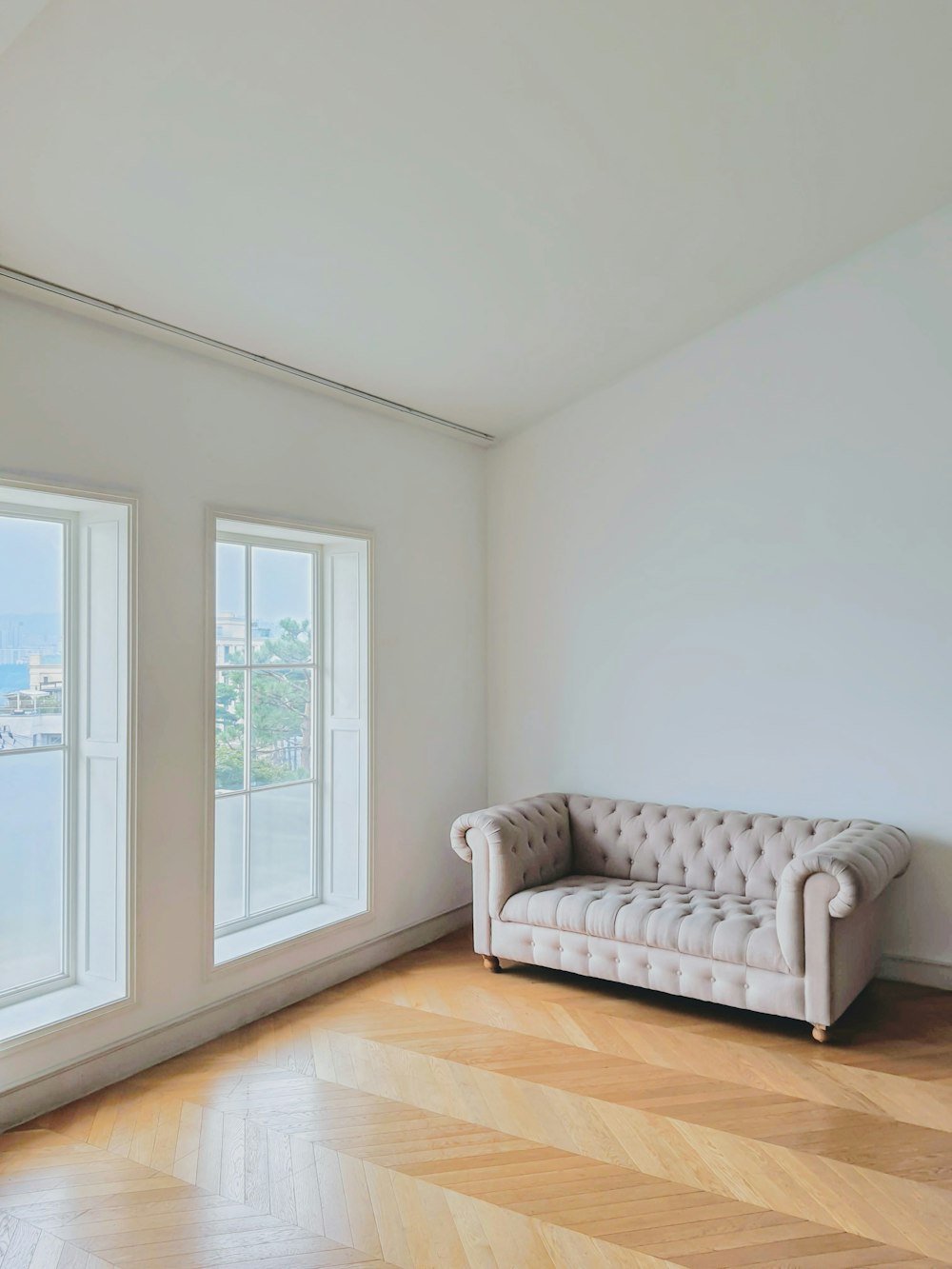 a living room with a couch and two windows