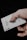 a person holding a playing card in their hand