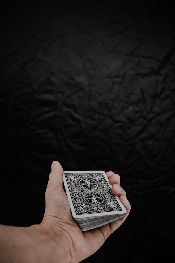 a person holding a playing card in their hand