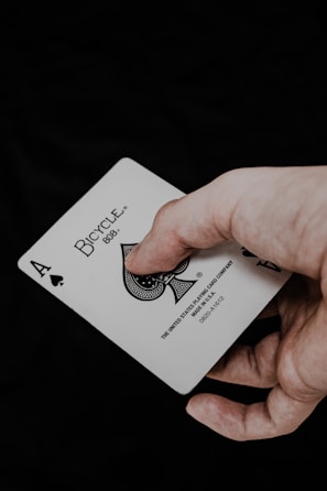 a person holding a playing card in their hand