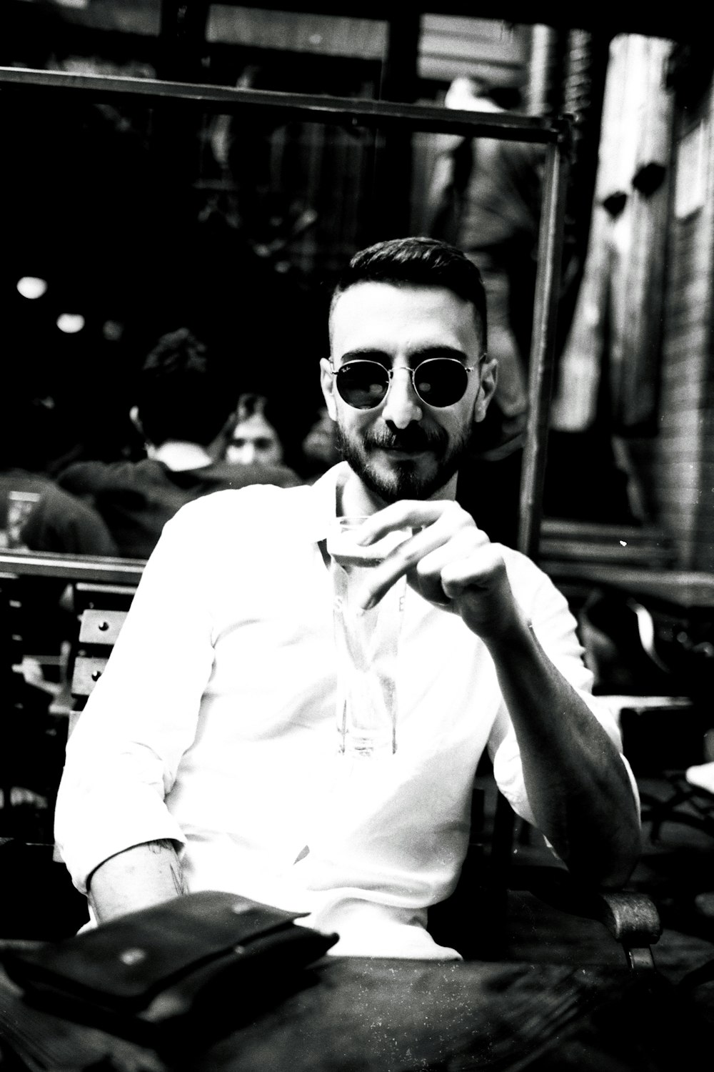 a man sitting at a table in front of a mirror