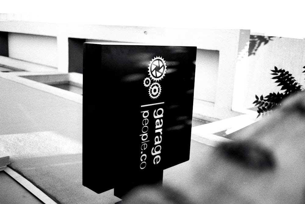 a black and white photo of a sign for a skate park