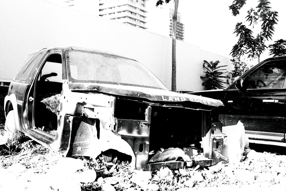 a black and white photo of a wrecked car