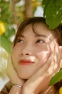a woman with her hands on her face