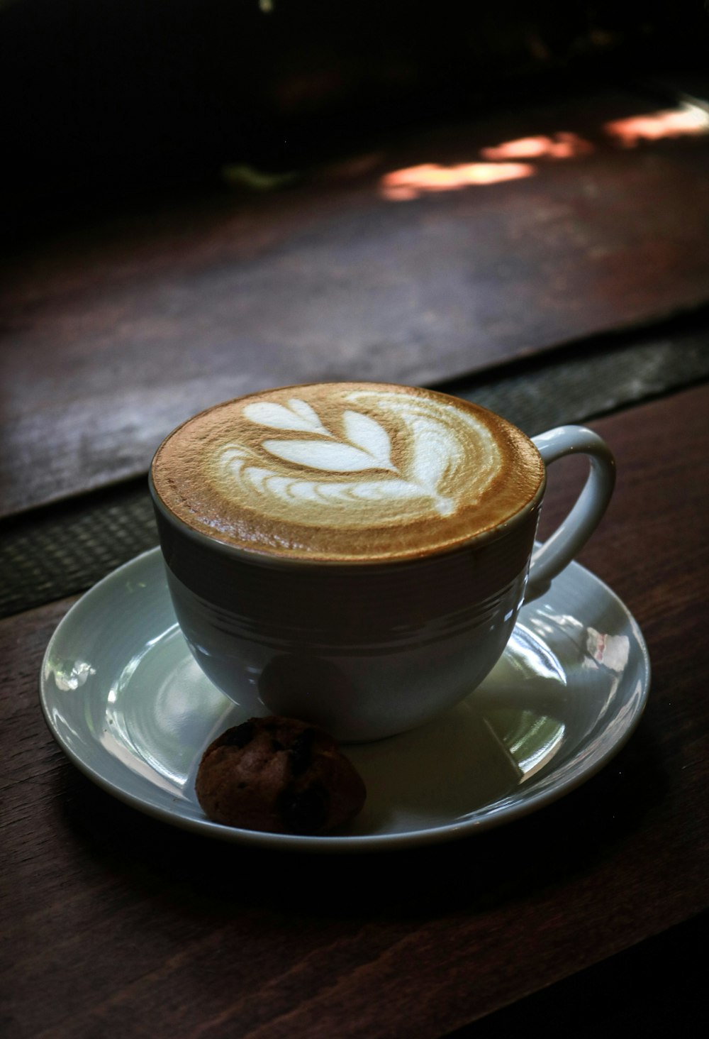 a cappuccino on a saucer on a table