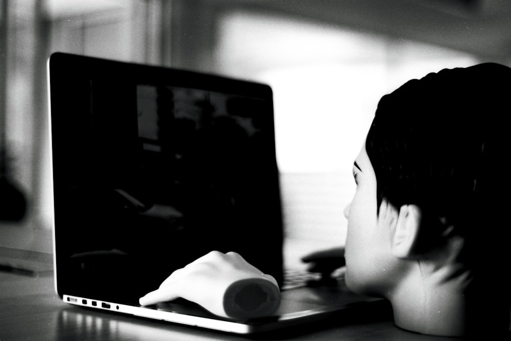 a person sitting in front of a laptop computer