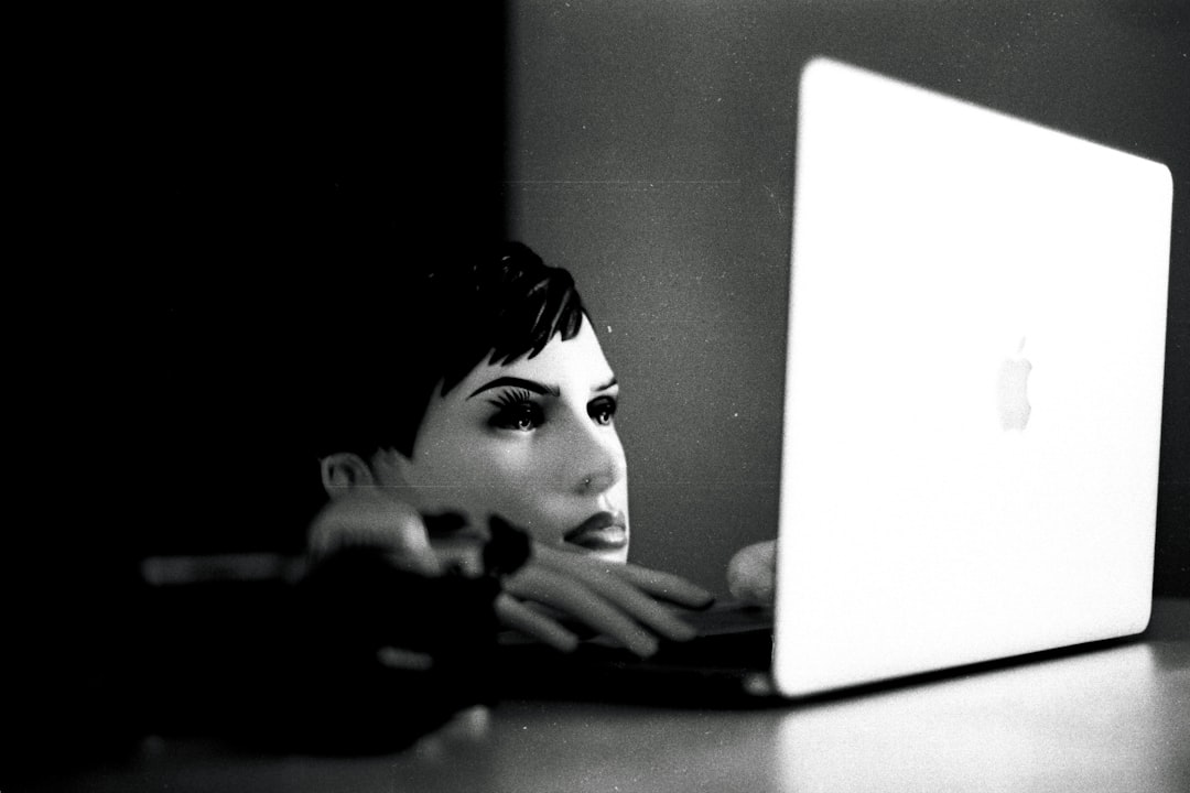 a black and white photo of a woman using a laptop, Mixed shots from me.</p>
<p>Nikon FE2</p>
<p>Fujifilm Across 100 II