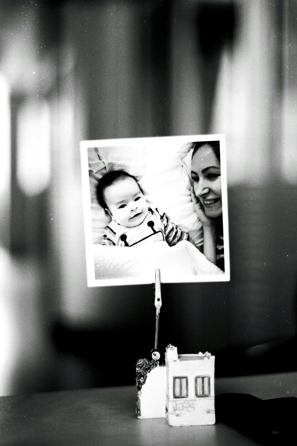 a black and white photo of a woman holding a baby