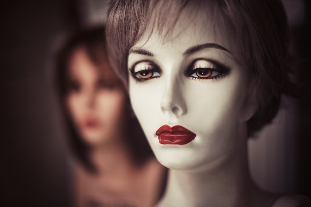a mannequin's head with a red lipstick on it