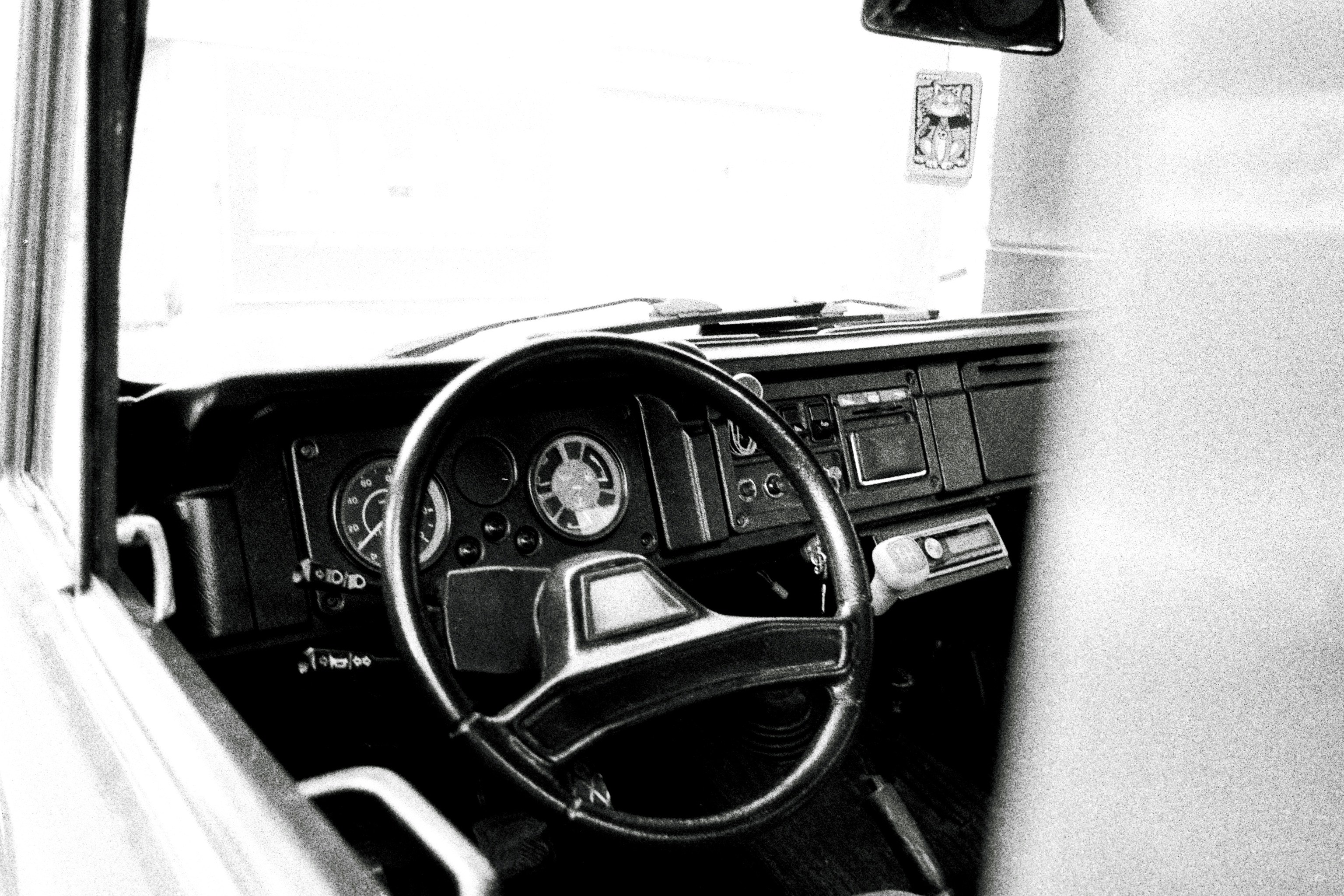 Driver in a modern electric automobile showing the dashboard and navigation while driving