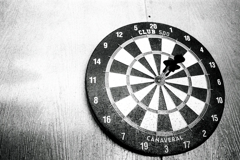 a dart hitting in the center of a dartboard