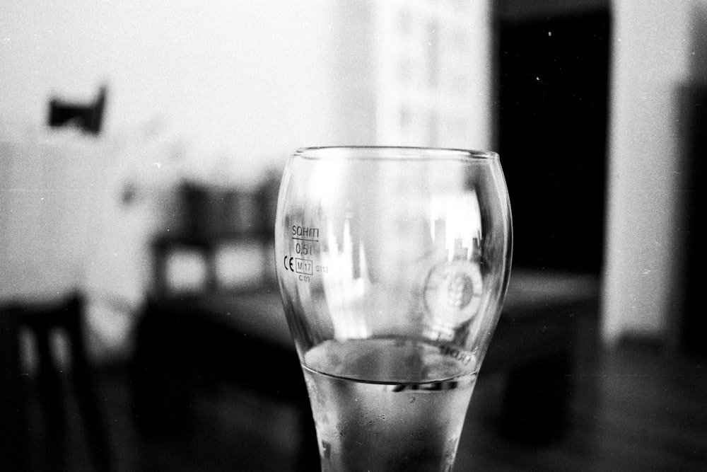 a black and white photo of a glass on a table