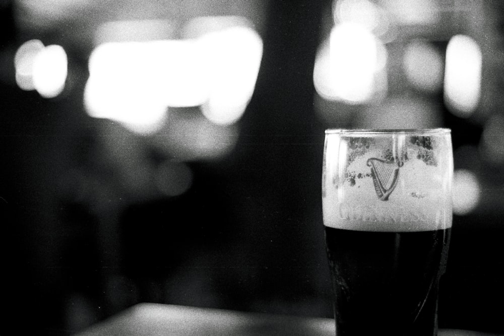 a black and white photo of a glass of beer