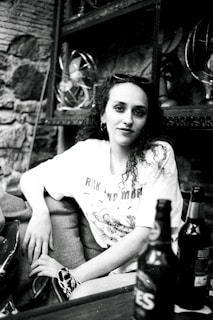 A model wearing a humorous t-shirt in a casual setting.