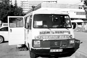 Van parked in a Paris street with company branding for shutter repair.