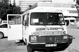Van parked in a Paris street with company branding for shutter repair.