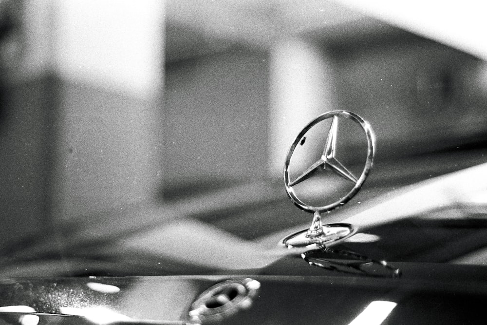 Una foto en blanco y negro de un emblema de Mercedes